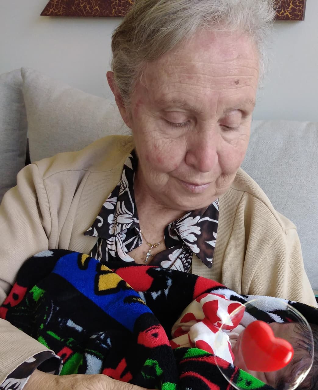 Delma holding a newborn baby, shared for her fundraising campaign